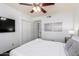 Comfortable bedroom features a ceiling fan, closet, and decorative wall art at 4556 E Paradise Ln, Phoenix, AZ 85032