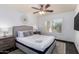Bright bedroom featuring a ceiling fan and a window with plantation shutters at 4556 E Paradise Ln, Phoenix, AZ 85032