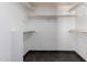 Walk-in closet with dark tile flooring and white shelving at 4556 E Paradise Ln, Phoenix, AZ 85032