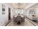 Bright dining room with modern lighting, ample seating, and an open layout connecting to the living area at 4556 E Paradise Ln, Phoenix, AZ 85032