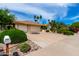 Charming home with mature landscaping, a spacious driveway, and a three-car garage at 4556 E Paradise Ln, Phoenix, AZ 85032