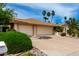 Well-maintained home exterior with a spacious driveway and a three-car garage at 4556 E Paradise Ln, Phoenix, AZ 85032