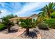 Landscaped front yard with vibrant plants, a brick pathway, and a two-car garage at 4556 E Paradise Ln, Phoenix, AZ 85032