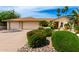 Well-maintained front yard featuring desert landscaping and a three-car garage at 4556 E Paradise Ln, Phoenix, AZ 85032