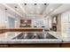 Bright kitchen features granite countertops, wooden cabinets, and a smooth cooktop with modern pendant lighting at 4556 E Paradise Ln, Phoenix, AZ 85032