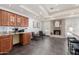 Open kitchen area with ample cabinet space, granite countertops, and a cozy seating area near a fireplace at 4556 E Paradise Ln, Phoenix, AZ 85032
