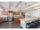 Open concept kitchen with stainless steel appliances, a large island and ample storage at 4556 E Paradise Ln, Phoenix, AZ 85032
