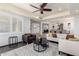 Bright living room features a ceiling fan, comfortable seating, and an open floor plan leading to the dining area at 4556 E Paradise Ln, Phoenix, AZ 85032