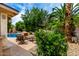 Inviting patio area next to the pool with comfortable seating arrangements and tropical landscaping at 4556 E Paradise Ln, Phoenix, AZ 85032