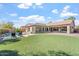 Spacious backyard with lush lawn, swimming pool, and covered patio perfect for outdoor living at 4589 N 154Th Ave, Goodyear, AZ 85395
