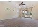 Bright bedroom with multiple windows, ceiling fan, and sliding door to the backyard at 4589 N 154Th Ave, Goodyear, AZ 85395