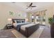Primary bedroom with a large bed, backyard access, and stylish nightstands at 4589 N 154Th Ave, Goodyear, AZ 85395