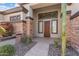 Inviting front entrance featuring stone accents, desert plants, and a decorative wood door at 4589 N 154Th Ave, Goodyear, AZ 85395