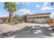 Charming exterior with desert landscaping, a three-car garage, and a patterned concrete driveway at 4589 N 154Th Ave, Goodyear, AZ 85395