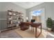 Stylish home office with a large desk, shelving, and a view of the backyard at 4589 N 154Th Ave, Goodyear, AZ 85395