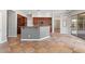 Spacious open kitchen with a central island, bar seating, and sliding door to the backyard at 4589 N 154Th Ave, Goodyear, AZ 85395