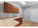 Functional laundry room boasts ample counter space and cabinetry for storage at 4589 N 154Th Ave, Goodyear, AZ 85395