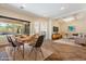 Living room with dining table showcasing an open-concept design, backyard view, and stylish decor at 4589 N 154Th Ave, Goodyear, AZ 85395
