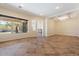 Spacious living room featuring tile floors, recessed lighting, and a decorative coffered ceiling at 4589 N 154Th Ave, Goodyear, AZ 85395