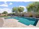 Refreshing backyard swimming pool surrounded by lush landscaping and privacy fence at 4589 N 154Th Ave, Goodyear, AZ 85395
