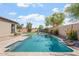 Sparkling pool in a private backyard with lush landscaping, a block fence, and ample space for entertaining at 4589 N 154Th Ave, Goodyear, AZ 85395