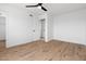 Bright bedroom featuring hardwood floors, a ceiling fan, and a walk-in closet, offering ample storage space at 4629 E Southern Ave, Phoenix, AZ 85042