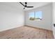Bright bedroom with ceiling fan, hardwood floors, and a large window offering ample natural light at 4629 E Southern Ave, Phoenix, AZ 85042
