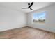 Serene bedroom with wood floors, a modern ceiling fan, and a large window view at 4629 E Southern Ave, Phoenix, AZ 85042
