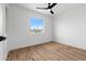 Bright bedroom with a ceiling fan and large window offering ample natural light and hardwood floors at 4629 E Southern Ave, Phoenix, AZ 85042