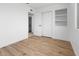 Spacious bedroom features hardwood floors, closet with shelving, and adjacent bathroom for added convenience at 4629 E Southern Ave, Phoenix, AZ 85042