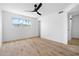 Bright bedroom with a ceiling fan and stylish wood flooring, offering a modern and comfortable space at 4629 E Southern Ave, Phoenix, AZ 85042