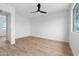Bright bedroom featuring hardwood floors, a ceiling fan, and a window at 4629 E Southern Ave, Phoenix, AZ 85042