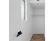 Bright closet featuring wood floors, a window, and shelving for optimal storage at 4629 E Southern Ave, Phoenix, AZ 85042