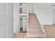 Inviting entryway with carpeted stairs and wood-look flooring, offering a warm welcome into the home at 4629 E Southern Ave, Phoenix, AZ 85042