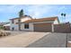 Well-kept, two-story home boasts an attached two-car garage and gravel landscaping at 4629 E Southern Ave, Phoenix, AZ 85042
