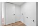 Bright laundry room featuring hardwood floors, white walls, and modern hookups for washer and dryer at 4629 E Southern Ave, Phoenix, AZ 85042