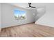 Bright, airy living room with wood floors, a ceiling fan, and a view to the outside at 4629 E Southern Ave, Phoenix, AZ 85042