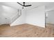 Inviting living room featuring wood floors, ceiling fan, and staircase access at 4629 E Southern Ave, Phoenix, AZ 85042