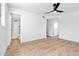 Bright main bedroom with wood floors, ceiling fan and access to a bathroom with shower at 4629 E Southern Ave, Phoenix, AZ 85042
