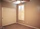 Well-lit bedroom features a ceiling fan, closet, plantation shutters and hardwood flooring at 4747 E Narrowleaf Dr, Gilbert, AZ 85298