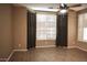 A comfortable bedroom featuring plantation shutters, hardwood flooring and ambient lighting at 4747 E Narrowleaf Dr, Gilbert, AZ 85298