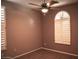 A spacious bedroom with a ceiling fan and ample natural light with stylish shuttered windows at 4747 E Narrowleaf Dr, Gilbert, AZ 85298