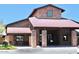 Beautiful clubhouse exterior with brick accents and a well-kept landscape creating an inviting atmosphere at 4747 E Narrowleaf Dr, Gilbert, AZ 85298