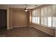 Spacious living area with a ceiling fan and ample natural light from shuttered windows at 4747 E Narrowleaf Dr, Gilbert, AZ 85298
