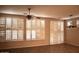 Bright living room featuring plantation shutters, ceiling fan, and hardwood flooring at 4747 E Narrowleaf Dr, Gilbert, AZ 85298