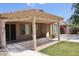 Spacious covered patio with pavers, landscaping, and sliding glass door at 4747 E Narrowleaf Dr, Gilbert, AZ 85298