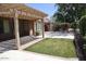Covered patio with pavers, green lawn, and desert landscaping in backyard at 4747 E Narrowleaf Dr, Gilbert, AZ 85298