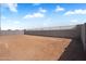 Spacious backyard with block fence ready for landscaping and outdoor activities at 4811 W Hunter Trl, San Tan Valley, AZ 85144