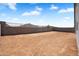 Spacious backyard with block fence and mountain views ready for landscaping and outdoor activities at 4811 W Hunter Trl, San Tan Valley, AZ 85144