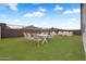 Virtual staged landscaped backyard showcases an inviting patio set, perfect for outdoor relaxation at 4811 W Hunter Trl, San Tan Valley, AZ 85144